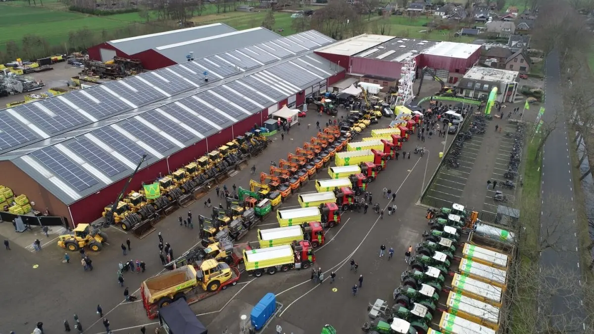 Luchtfoto van een bedrijfsterrein met rijen shovels, vrachtwagens en tractoren