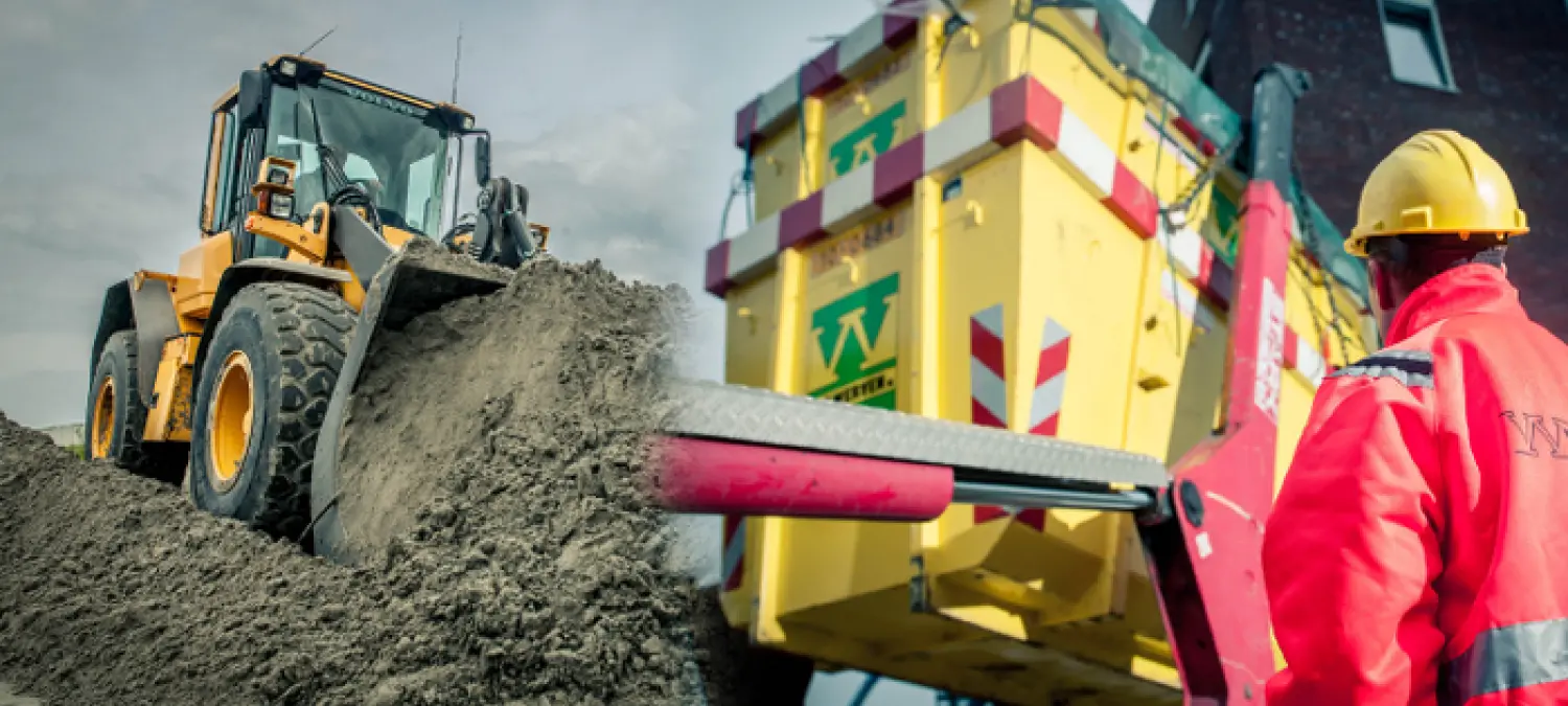 Wiellader schuift zand naast een gele container, werkman in rode overall
