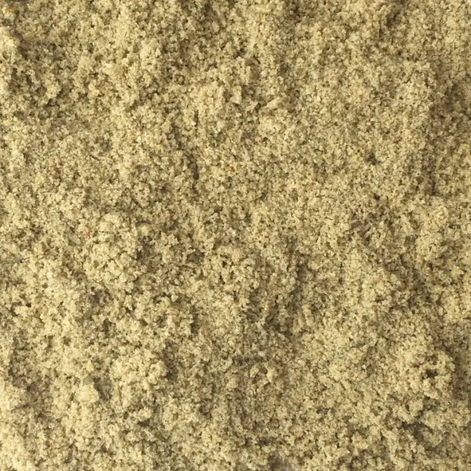 Close-up van fijn geelbeige bunkerzand met korrelige structuur